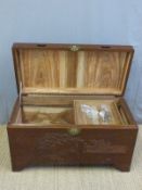 A carved oriental chest with camphor lining and decoration of a fishing scene (H56 x L103 x D50)