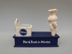 A 'Pillsbury Dough' advertising cast iron money box containing a collection of brass threepenny