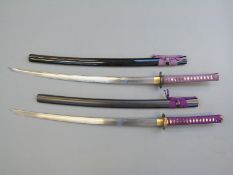 Two Samurai swords with decorative guards and lacquered scabbards, blade length 73cm,