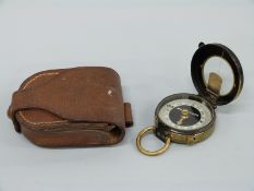 A cased military style compass