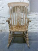 A beech Windsor rocking chair