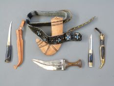 Three knives comprising a horn handled jambia dagger with sheath and belt, blade length 21cm,