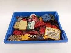 A collection of Meccano parts including wheels and axles