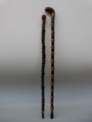 Two late 19th/early 20thC walking sticks comprising a carved briar stick with grotesque pirate head