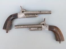 A pair of percussion hammer action side by side pistols with chequered locks, carved reeded grip,