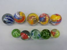 Ten large glass marbles, all with multicoloured decoration,