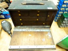 A vintage wooden toolmaker's chest and contents to include punches,
