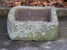 A small D ended carved natural stone trough (L53 x W46 x H20cm)