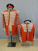 Two military uniforms comprising two drummer's tunics, one Coldstream Guards,