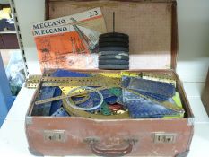 A collection of Meccano including blue and yellow parts, wheels etc,