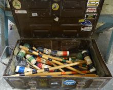 A child's croquet set in a metal ammunition type box