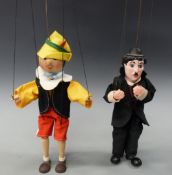 Two vintage puppets Pinnocchio and Charlie Chaplin each approximately 30cm tall excluding wires.