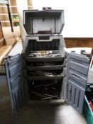 A wheeled three-tier cabinet and contents including spanners
