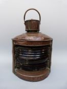 A large copper port ship's navigation lamp,