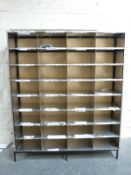 A large cubbyhole shelf unit with shopfitting steel frame and 32 cubbyholes,