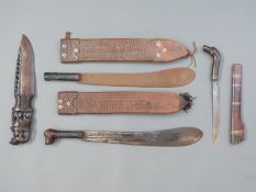 Two African machetes, one with dog's head handle, blade length 45cm the other with plain handle,