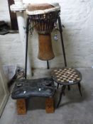 An African drum on metal stand,