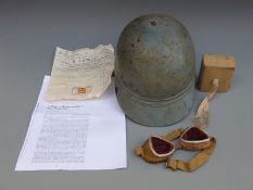 A motor racing or similar helmet and goggles,