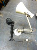 An anglepoise lamp and magnifier type example