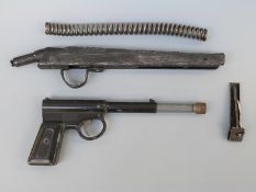 T J Harrington & Son The Gat pistol together with an air rifle spring and two air rifle parts