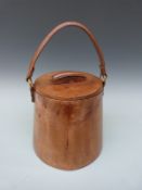 A vintage leather ice bucket with liner
