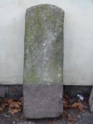 A carved natural stone marker or milepost with number 18 carved to top (approximate H90 x W29 x