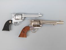 Two replica six-shot revolvers, one BKA with 7inch barrel and shaped mahogany grips,