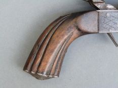 A pair of percussion hammer action side by side pistols with chequered locks, carved reeded grip,