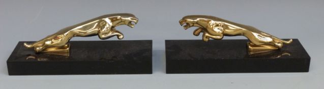Two Jaguar mascots on bases,