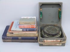 A cased P10 military aircraft compass and books