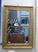 An ornate bevelled glass mirror