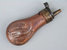 Copper and brass pistol powder flask with embossed decoration of an American style eagle holding a