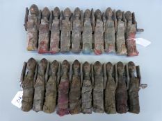 A pair of 19thC/20thC carved African figural groups with bound cloth bodies.