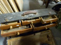 A vintage fitted tool chest containing various planes and other woodworking tools
