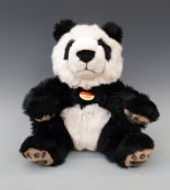 Steiff Teddy bear Manschli panda with black and white fur and print to pads,