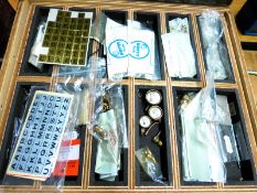 A box of model engineering items including live steam pressure gauges, reversing quadrant,