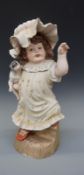 A large German ceramic figure of a girl with puppy, impressed number 880 verso,