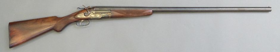 Unnamed 10 bore single barrelled hammer action shotgun with engraved lock, stylized dolphin hammer,