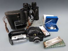 A cased pair of Swift binoculars, Olympus Trip XB400 and 35 cameras,