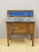 An oak tile backed washstand (H94 x W77 x D46cm)