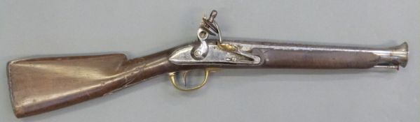Flintlock hammer action blunderbuss with brass trigger guard and flash pan,