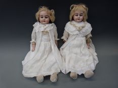 A pair of Armand Marseille bisque headed 'Alma' dolls with open mouths,