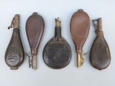 Five leather shot flasks one with embossed decoration of dogs and game birds.