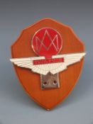 An Aston Martin Owners' Club badge on shield shaped stand, height 17.