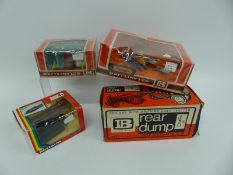 Four Britains model farm implements Rear Dump 9629, Ploughs 9546, Crop Spray 9548 and Log Sled 9412,