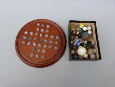 A vintage solitaire set with 32 glass marbles with multicoloured latticino twists,