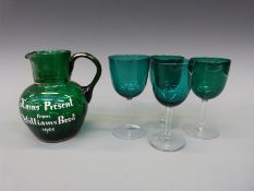 Victorian glass jug with applied script 'Xmas Present from Williams Bros' and four glasses,