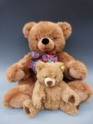 Two Steiff Cosy Friends Teddy bears one with tartan bow tie, 70cm tall, the other with pale snout,