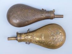 Two American brass powder flasks both with embossed scenes of shaking hands below a crested eagle