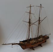 A 20thC model of a ship inscribed 'In Toulaisse' of plank construction (100cm long) together with a